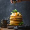 Sweet Delight: Drizzling honey over perfect pancakes